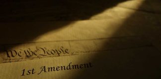 "1st Amendment" document in dramatic lighting.
