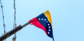 Venezuelan flag flying on a pole.