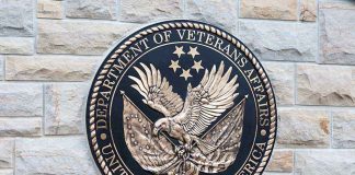 Department of Veterans Affairs seal on brick wall.
