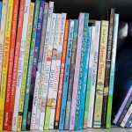 Colorful childrens books lined up on a shelf