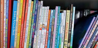 Colorful childrens books lined up on a shelf
