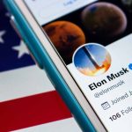 Twitter profile on smartphone with American flag.