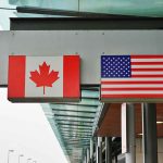 Canadian and American flags on building signs