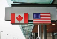 Canadian and American flags on building signs