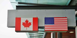 Canadian and American flags on building signs