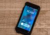 Incoming call labeled "SCAM" on smartphone screen.