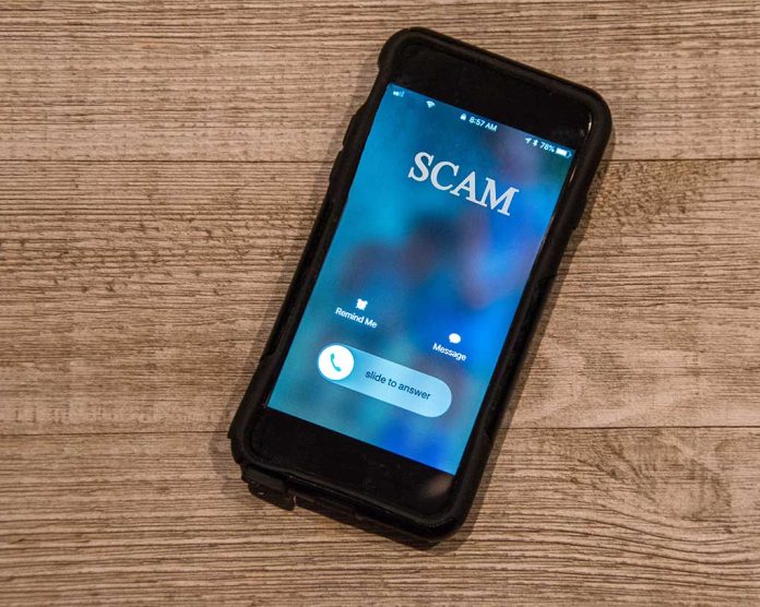 1252782130 featured image Incoming call labeled "SCAM" on smartphone screen.