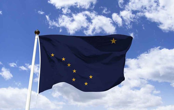 1363238492 featured image Alaska state flag flying against a blue sky.