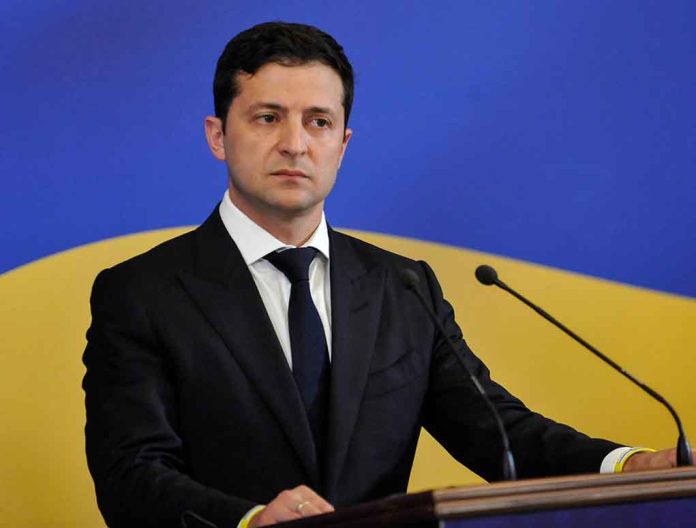 1448861675 featured image Man in suit speaking at podium with microphones.