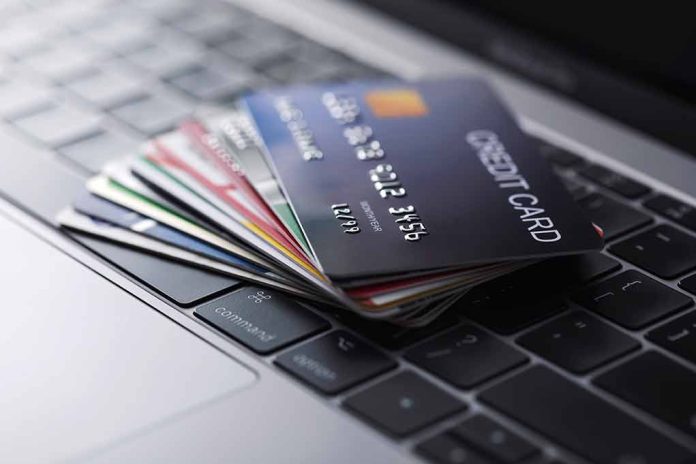1722681316 featured image Stack of credit cards on a laptop keyboard.