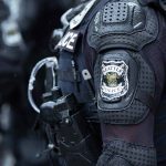 Seattle Council Member Suggests Major Funding Shift for Enhanced Safety Strategies Seattle police officer in protective gear.