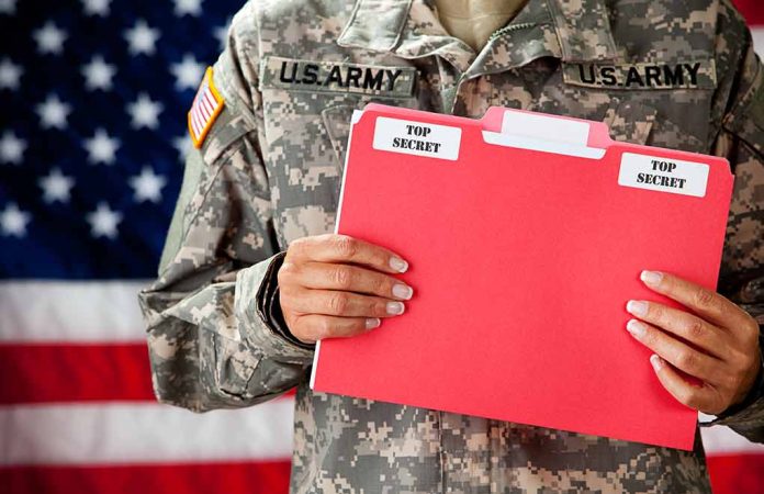 177221078 featured image Soldier holding red top secret file folder.