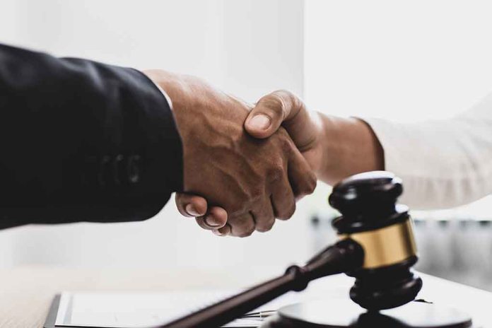 1789915493 featured image Handshake over a table with a gavel.