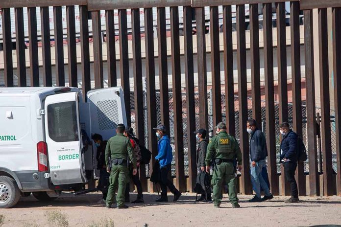 2079408475 featured image Border patrol agents detaining people near a fence