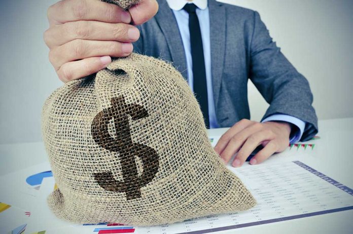324821675 featured image Person holding burlap sack with dollar sign.