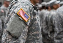 People in camouflage uniforms with US flag patch