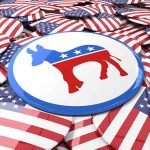 Senator Raises Alarms Over Party Image and Working-Class Appeal Political buttons with American flags and donkey symbol.