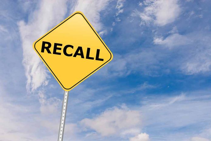 529192612 featured image Yellow "Recall" road sign against a cloudy sky.