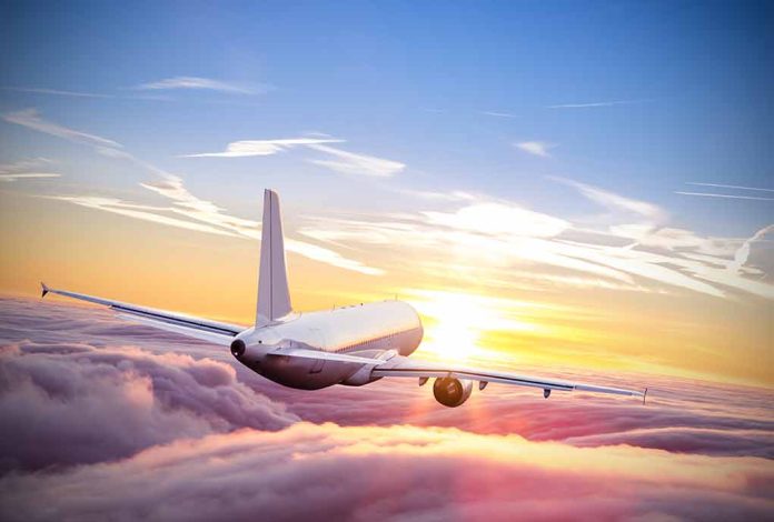 553131187 featured image Airplane flying above the clouds at sunset