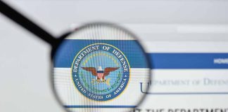 Magnifying glass over Department of Defense logo.