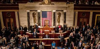 People gathering inside a government building legislative chamber
