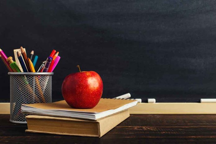1248611965 featured image Apple on books with pencils beside a chalkboard.