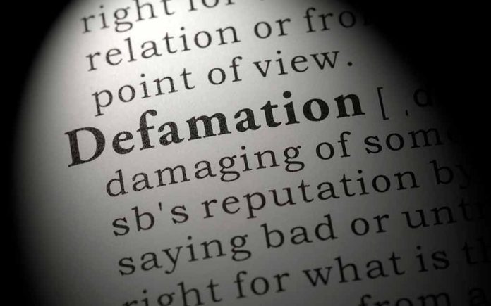 1886365714 featured image Close-up of the word Defamation in a dictionary.
