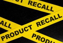 Yellow tape with product recall text on black background
