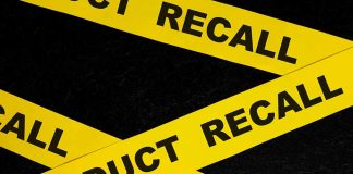 Yellow tape with product recall text on black background