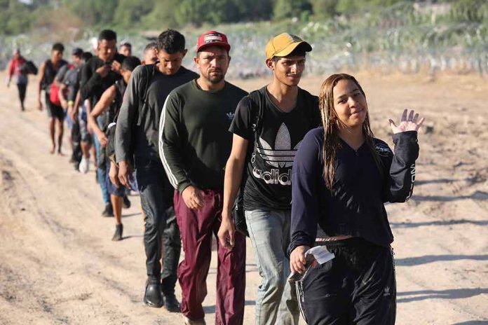 2364873693 featured image Line of people walking on a dirt road.