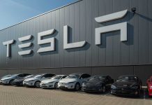 Tesla facility with parked cars in front.