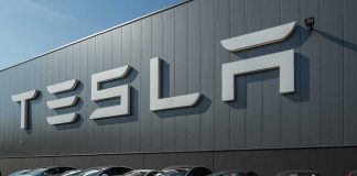 Tesla facility with parked cars in front.