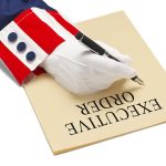 Hand writing executive order on paper