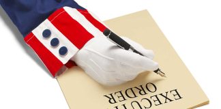 Hand writing executive order on paper