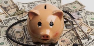 Piggy bank stethoscope money scattered underneath currency bills