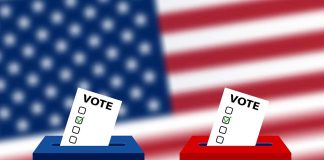 Ballots in boxes with American flag background