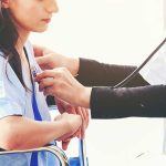 Doctor examining patient with a stethoscope