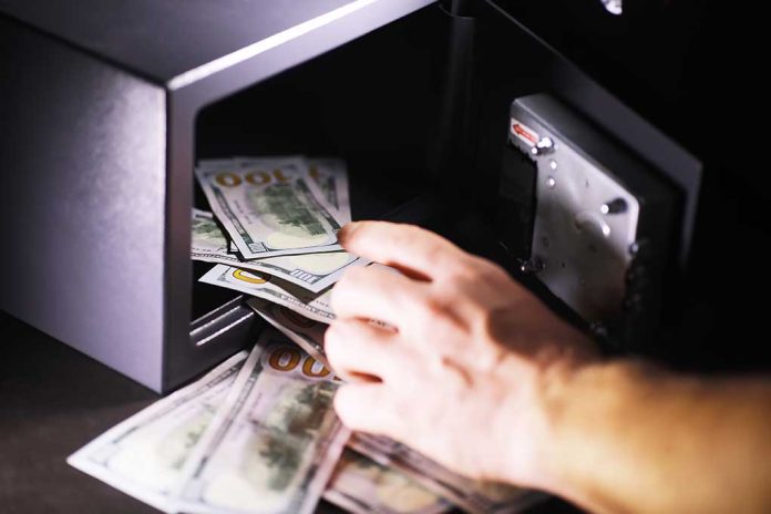 1863533221 featured image Hand putting cash into a safe.