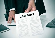 Person holding a document labeled Lawsuit