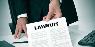 Person holding a document labeled Lawsuit