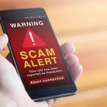 Phone showing scam alert warning message