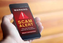 Phone showing scam alert warning message