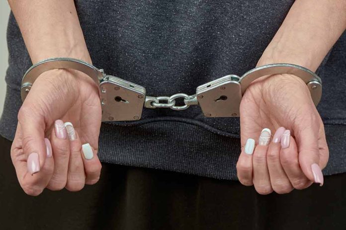 2295282433 featured image Hands with manicured nails in handcuffs.