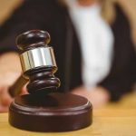 Judge using a gavel in courtroom