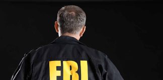 Person wearing jacket with FBI printed on back