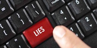 Finger pressing lies key on keyboard.