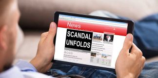 Person reading tablet with headline Scandal Unfolds