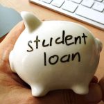 Person holding piggy bank labeled student loan