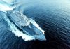 Military ship moving fast on the ocean