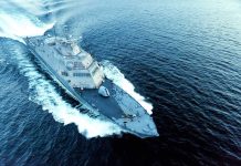 Military ship moving fast on the ocean